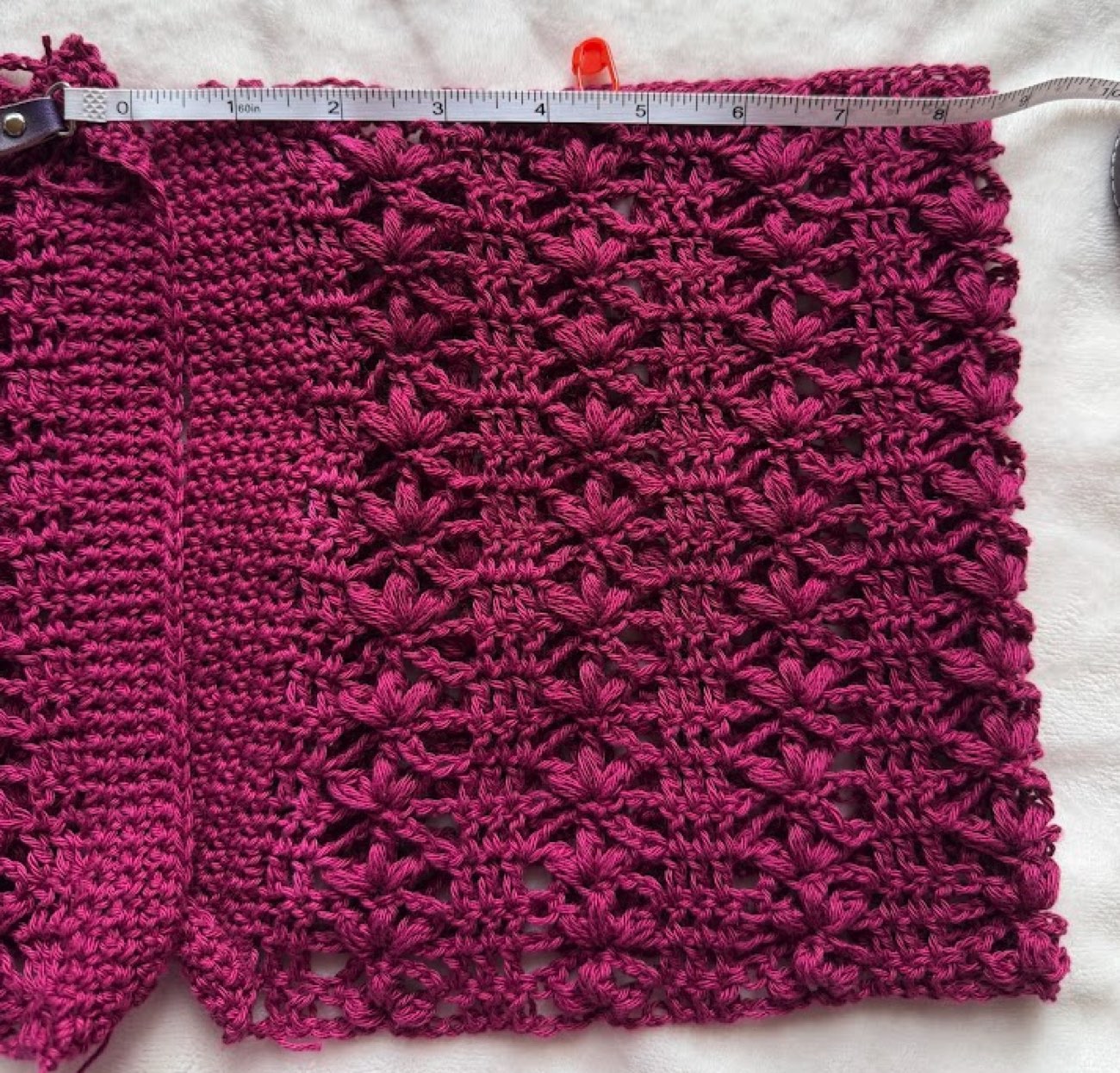 Measuring the crocheted panel with a tape measure